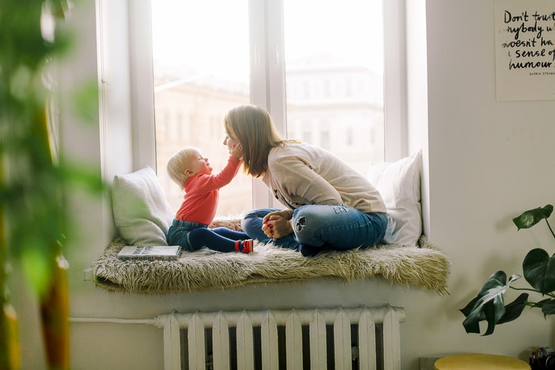 toddler and mum sitting on a window seat