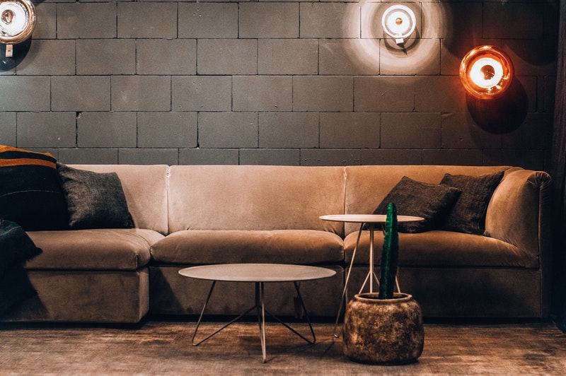 a tan suede sofa with cushions