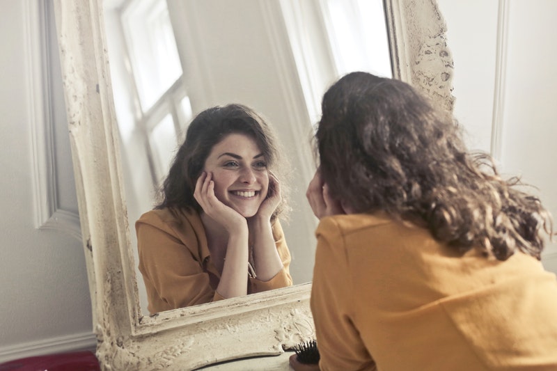 lady looking into a mirror and smiling