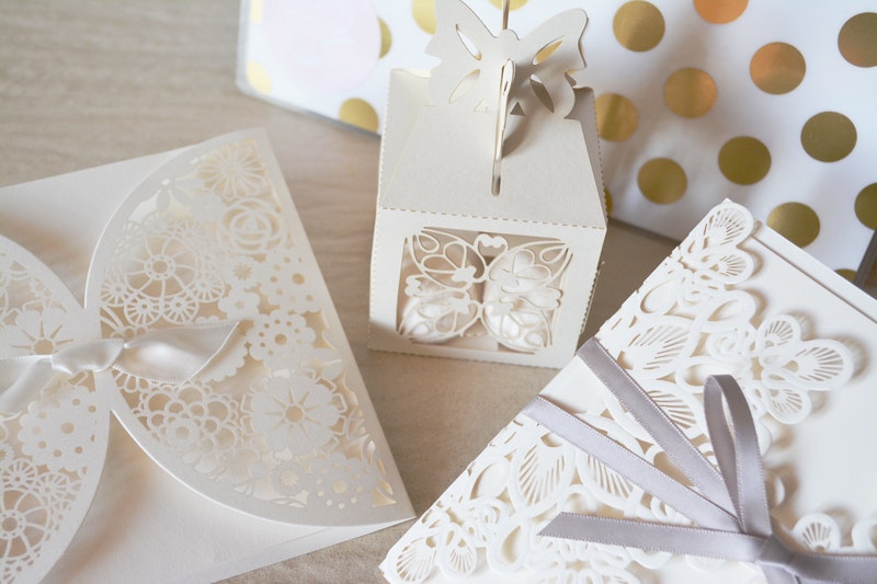 Dainty white wedding favor boxes with butterfly motif